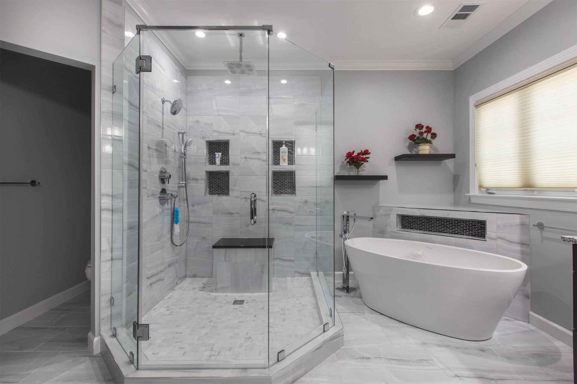 Walk-in shower with frameless glass and freestanding tub in a GBC primary bath remodel