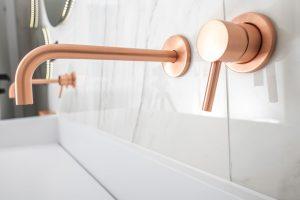 Brass or gold colored water fixtures in the bathroom