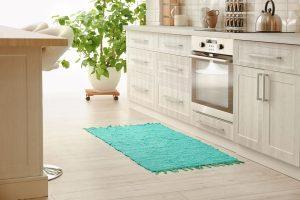 Kitchen with water damaged laminate floors