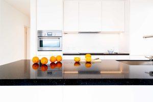 white kitchen with dark granite countertops