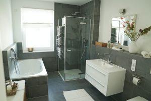 shower with glass enclosure, door open outward